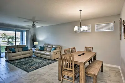 a living room with a table and chairs and a couch at Kissimmee Condo with Resort-Style Amenities! in Kissimmee