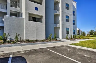 a parking lot in front of a building at Kissimmee Condo with Resort-Style Amenities! in Kissimmee
