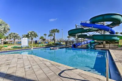a water slide at a resort with a swimming pool at Kissimmee Condo with Resort-Style Amenities! in Kissimmee