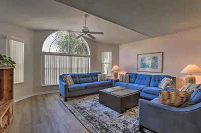 a living room with blue couches and a ceiling fan at Close to Disney and Resort Perks Kissimmee Condo in Kissimmee