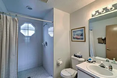 a bathroom with a shower and a toilet and a sink at Close to Disney and Resort Perks Kissimmee Condo in Kissimmee