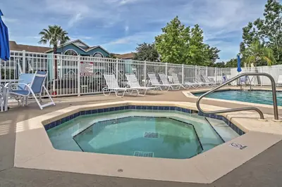 a swimming pool with lounge chairs and a swimming pool at Close to Disney and Resort Perks Kissimmee Condo in Kissimmee