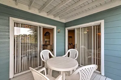 a table and chairs on the porch of a house at Close to Disney and Resort Perks Kissimmee Condo in Kissimmee