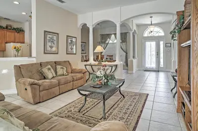 a living room with a couch and a table at 4 Mi to Disney Kissimmee Group Getaway in Orlando