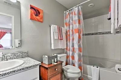 a bathroom with a sink and a toilet and a shower at Theme Park Retreat with 5-Star Amenities - By Disney in Kissimmee