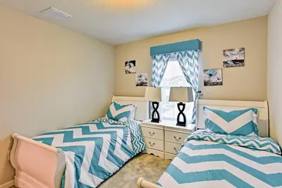 a bedroom with two beds and a window at Theme Park Retreat with 5-Star Amenities - By Disney in Kissimmee