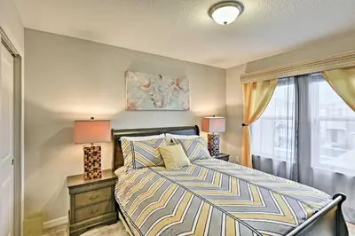 a bedroom with a bed and a window at Theme Park Retreat with 5-Star Amenities - By Disney in Kissimmee
