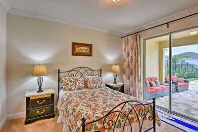 a bedroom with a bed and a balcony at 5 Mi to Disney Oasis with Pool and Patio in Orlando