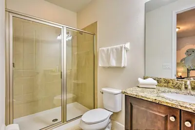 a bathroom with a shower and a toilet and a sink at 5 Mi to Disney Oasis with Pool and Patio in Orlando
