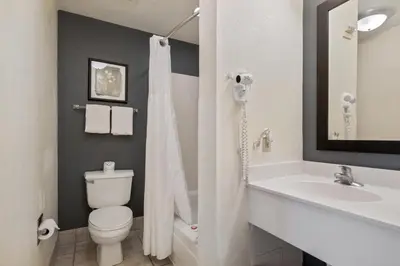 a bathroom with a toilet and a sink at Suburban Studios Orlando - Ocoee-Winter Garden in Orlando
