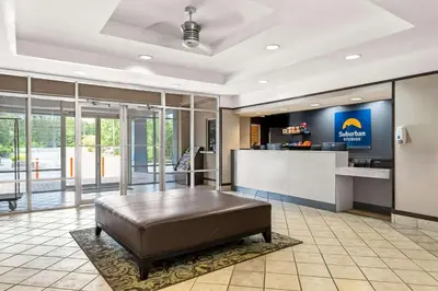 a large lobby with a bed and a bar at Suburban Studios Orlando - Ocoee-Winter Garden in Orlando