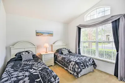a bedroom with two beds and a window at Retreat with Pool 25 Mi to Disney in Kissimmee