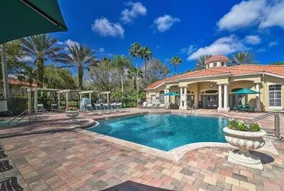 a house with a swimming pool in front of a house at Retreat with Pool 25 Mi to Disney in Kissimmee