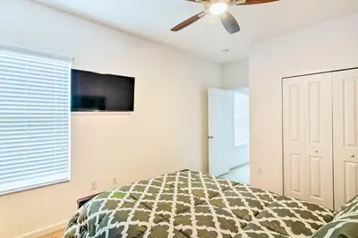 a bedroom with a bed and a ceiling fan at Home with Private Pool and Spa 8 Mi to Disney in Kissimmee