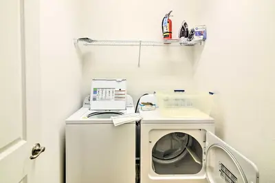 a laundry room with a washing machine and a washer at Home with Private Pool and Spa 8 Mi to Disney in Kissimmee