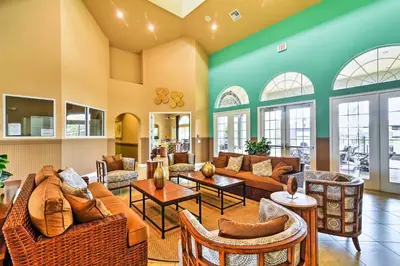 a living room with couches and tables at Home with Private Pool and Spa 8 Mi to Disney in Kissimmee