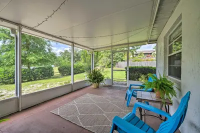 a screened porch with blue chairs and a table at Pet-Friendly Apopka Home 30 Mi to WDW! in Orlando