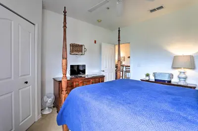 a bedroom with a blue bed and a television at Resort-Style Condo with Pool 6 Mi to Magic Kingdom in Kissimmee