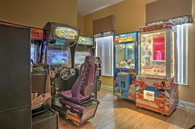 a group of arcade games in a room at 5 Mi to Disney Emerald Island Resort Condo! in Kissimmee