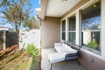 a porch with two white chairs and a window at 4 Mi to Dtwn Home with Pool Access in Sanford in Sanford