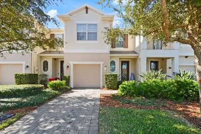 a large white house with a driveway at 4 Mi to Dtwn Home with Pool Access in Sanford in Sanford