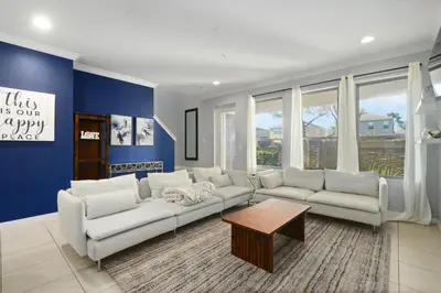 a living room with white furniture and blue walls at 4 Mi to Dtwn Home with Pool Access in Sanford in Sanford