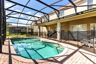 a swimming pool in a house with a glass roof at Spacious Kissimmee Villa - 3 Mi to Disney World! in Orlando