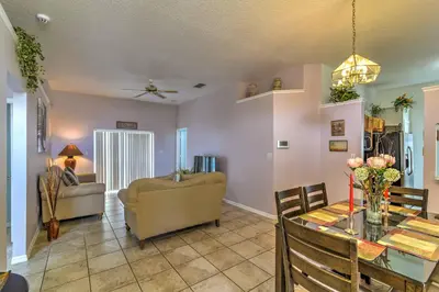 a living room with a table and a couch at Kissimmee Retreat with Pool Near Disney and Golf! in Kissimmee