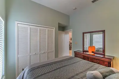 a bedroom with a bed and a mirror at Kissimmee Retreat with Pool Near Disney and Golf! in Kissimmee