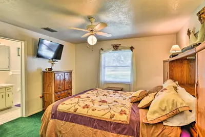 a bedroom with a bed and a ceiling fan at Sandford Vacation Rental Near Airport and Lake! in Sanford