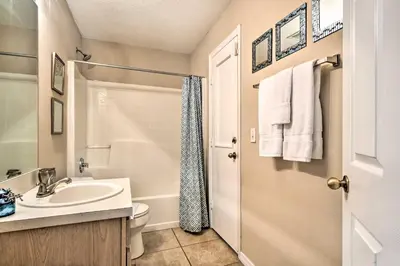 a bathroom with a sink and a toilet and a shower at Clermont Home with Pool and Game Room 10 Mi to Parks! in Orlando