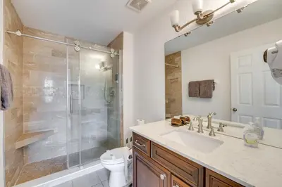 a bathroom with a shower and a sink and a toilet at Spacious Home in Gated Resort, 2 Mi to Disney! in Orlando