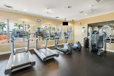 a gym with treadmills and elliptical machines at Spacious Home in Gated Resort, 2 Mi to Disney! in Orlando