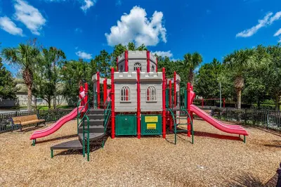 a playground with a slide in a park at Spacious Home in Gated Resort, 2 Mi to Disney! in Orlando