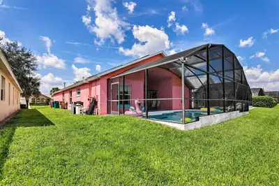 a house with a glass extension with a swimming pool at 5 Mi to Disney Parks Kissimmee Home with Game Room in Kissimmee