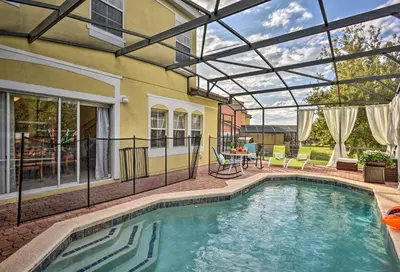 a swimming pool with a retractable roof on a house at 4 Mi to Animal Kingdom Gem with Pool in Kissimmee in Kissimmee