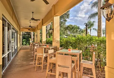 a row of tables and chairs on a patio at 4 Mi to Animal Kingdom Gem with Pool in Kissimmee in Kissimmee