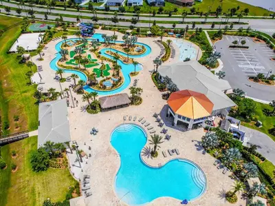 an overhead view of a pool at a resort at Lovely 2BR Codo with 2Clubhouses & Kids Splash Pad in Kissimmee