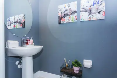 a bathroom with a sink and a mirror at Amazing Home w a Private Pool in Orlando