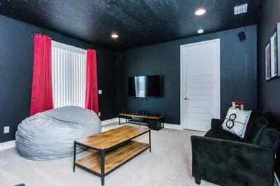 a bedroom with a bed and a table and a chair at Amazing Home w a Private Pool in Orlando