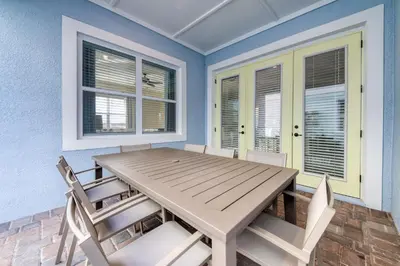 a dining room with a wooden table and chairs at 3 Story Cottage With Private Pool Near Disney With Margaritaville Resort & Island H20 Access - 8105Su in Orlando