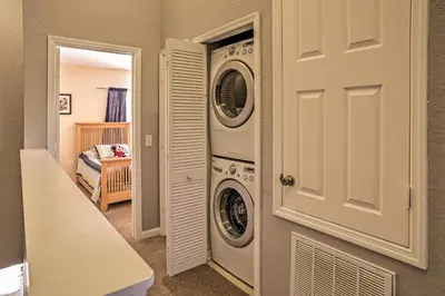 a laundry room with a washer and dryer next to a door at Our Mickey Mouse House Townhome with Pool! in Orlando