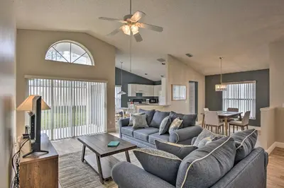 a living room with a couch and a tv at 7 Mi to WDW Indian Ridge Home with Pool Access! in Orlando