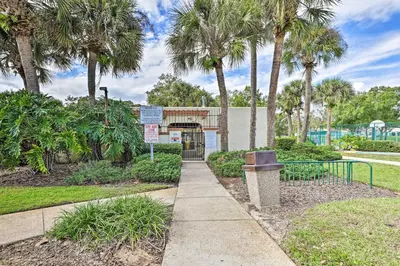 a park with palm trees and a trash can at 7 Mi to WDW Indian Ridge Home with Pool Access! in Orlando