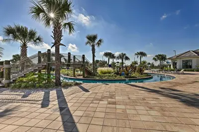 a resort with palm trees and a walkway at about 6 Mi to Disney Kissimmee Retreat with Pool! in Kissimmee