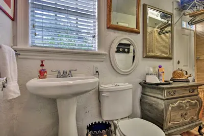 a bathroom with a sink and a toilet and a mirror at Lake Marion Apt with Canoe in Altamonte Springs! in Orlando