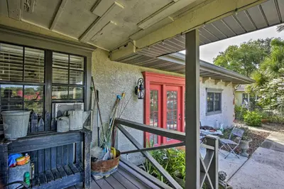 a house with a red door on a porch at Lake Marion Apt with Canoe in Altamonte Springs! in Orlando