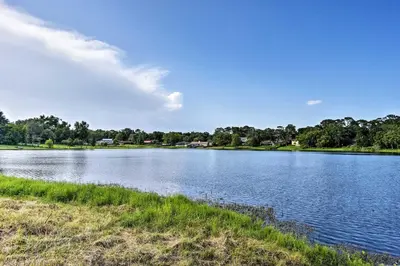 a large body of water with trees in the background at Lake Marion Apt with Canoe in Altamonte Springs! in Orlando