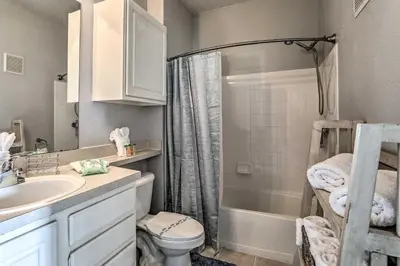 a bathroom with a sink and a toilet and a shower at Lake-View Condo with Pool Access 6 Mi to Disney! in Kissimmee