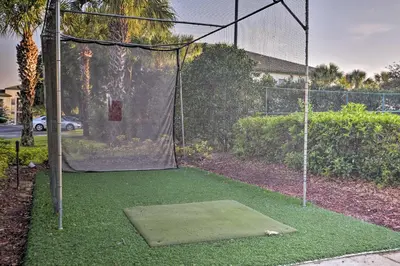 a batting cage with a net and some grass at Lake-View Condo with Pool Access 6 Mi to Disney! in Kissimmee